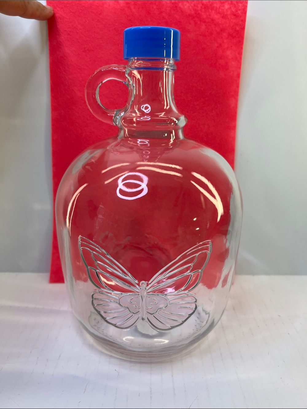 Dolly Parton Clear Glass Butterfly 64 fl oz Growler with Blue Cap. NWT